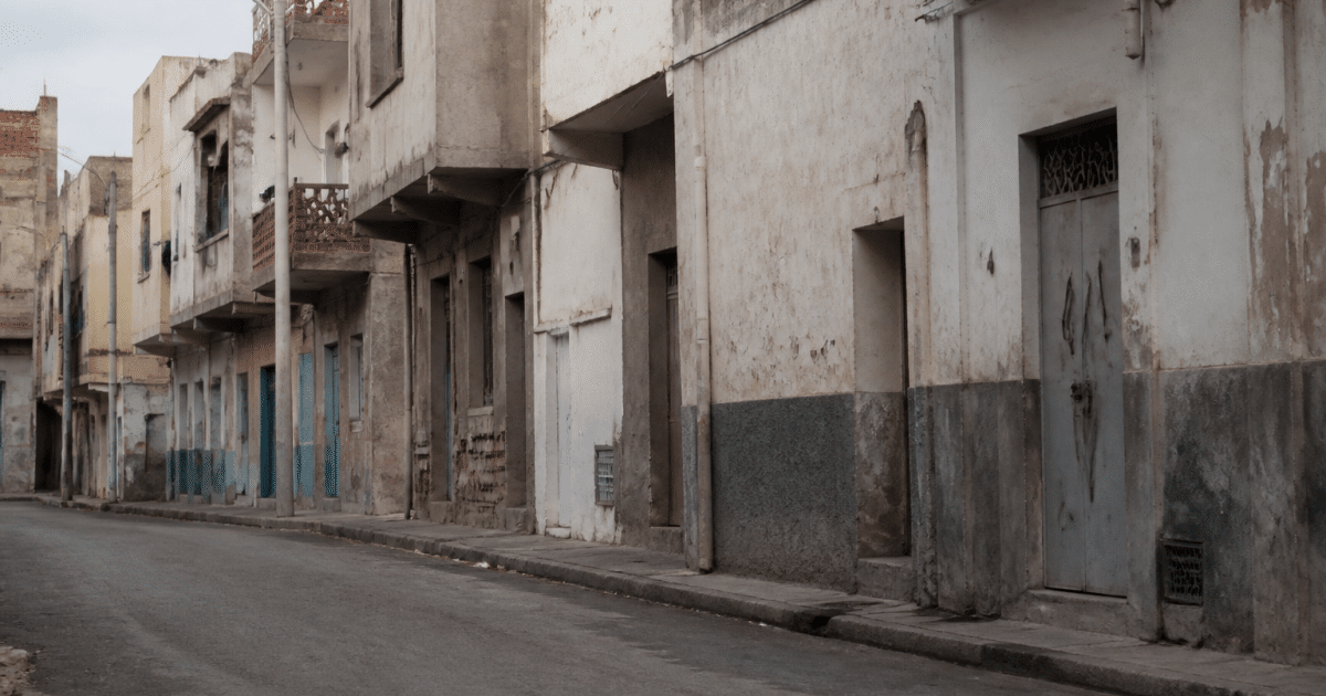 Rues desertes de quartier urbain avec immeubles degrades en arriere-plan